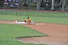 A baseball player sliding into second base during a game.