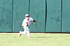 Baseball player running in the outfield.