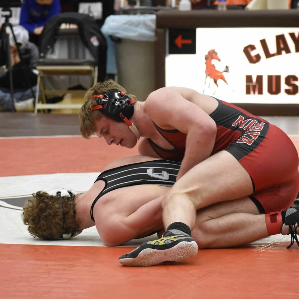Minerva senior Ethan Mueller (top) defeated Evan Lewis of Carrollton for the sectional title at152 lbs.