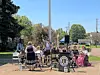 Community band performing outdoors with musicians and instruments.