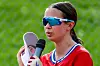 Young athlete with sunglasses speaking into a microphone.