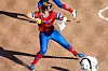 Softball player throwing a ball in a red and blue uniform.