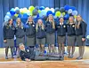 FFA members posing in front of a balloon arch.