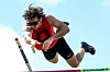 Athlete jumping over a pole vault bar.