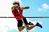 Athlete jumping over pole vault bar
