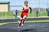 Athlete in red uniform sprinting on a track.