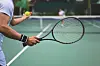 Tennis player with racket and ball on the court.