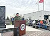 Military official speaking at a veterans' memorial ceremony.