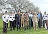 Veterans and officials pose together at an outdoor event.