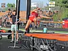 Athlete jumping over a high jump bar at a track event.