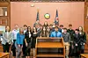 Students gathered in a courtroom for a mock trial event.