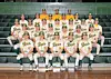 Baseball team in uniforms poses on bleachers.