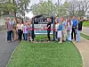 Group of people at a ribbon cutting ceremony for an Eyecare center.