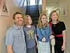 Family standing together at the top of a staircase.