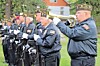 Veterans playing trumpet at a memorial ceremony.