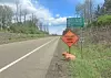 Roadside construction sign indicating shoulder work ahead.