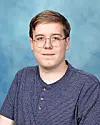 Student portrait with blue background.