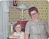 Woman and girl smiling together in a vintage living room.
