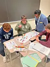 Students working on a project at a classroom table.