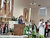A young person reading at a church lectern during a service.