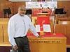 Pastor beside altar with Bible in church.