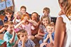 Children laughing and interacting during a classroom activity.