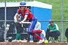 Softball player in red uniform ready to hit the ball.