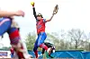 Softball player pitching on the field.