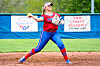 Softball player throwing a ball on the field.