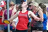 Female athlete in red uniform throwing a discus.
