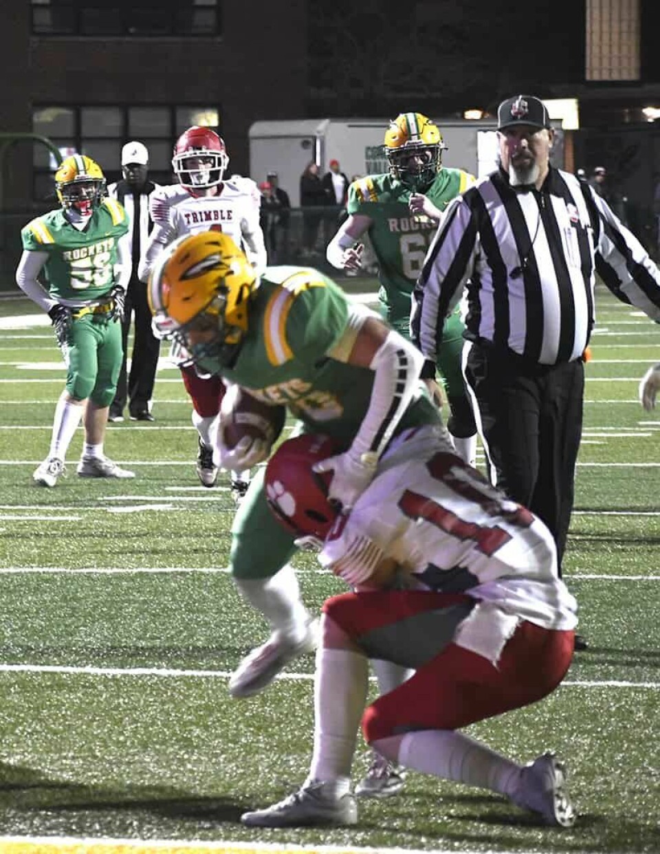 CCM/Pete McIntireRocket Gavin Haney (green) takes on Eli Riley (10) and wins the battle to score the Rockets’ first touchdown of the game Friday.