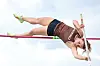 Female athlete pole vaulting over the bar.