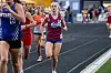 A runner in a red and blue uniform on a track.