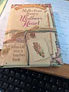Book on a desk with handwritten notes in the background.