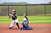 Softball players in action during a game.