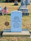 Grave marker of John Davis II with an American flag.