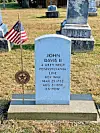 Grave marker of John Davis II with an American flag.