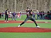 Baseball pitcher throwing a pitch on the field.