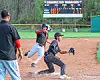Baseball players in action at Carrollton Warriors field.