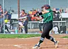 Softball player swings bat in action on the field.