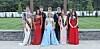 Group of contestants in formal wear outdoors.