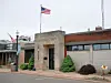 Exterior view of a government building with an American flag.