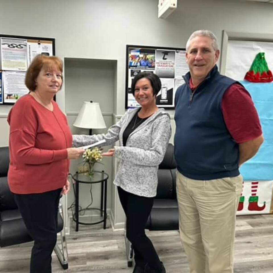 Submitted PhotoCarrrollton School Alumni Foundation President Susan Cogan (left) presents a check to Amy Spears, school treasurer, and Dave Davis, superintendent.