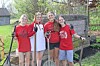 Group of volunteers with gardening tools at a community site.