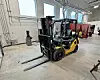 Forklift in an industrial setting with large windows.