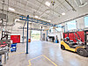Interior of a workshop with machinery and a forklift.