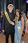 Prom king and queen smiling together at the event.