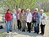 Seniors posing together outdoors under a tree.