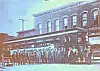 Historic streetcar and crew in front of a building.