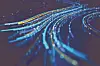 Abstract light trails in blue and yellow hues.